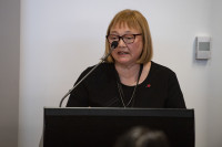 Bernadine MacKenzie speaking at a podium 