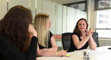 Three people in a meeting