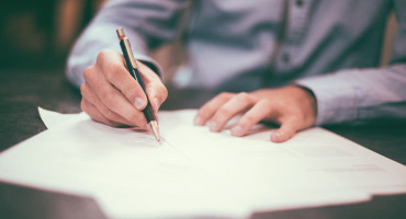 Close up of signing a document