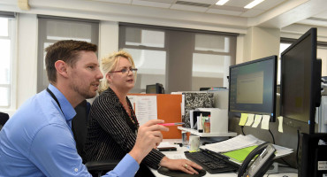 Two case managers working at a computer