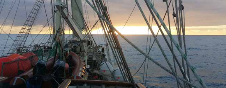 View of a sunset over the Pacific Ocean from the SV Tenacious