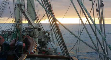 View of a sunset over the Pacific Ocean from the SV Tenacious