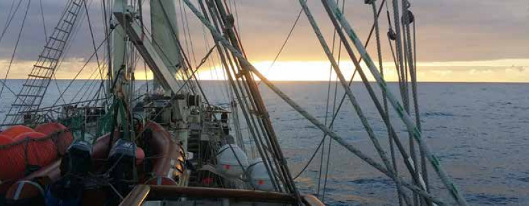 View of a sunset over the Pacific Ocean from the SV Tenacious