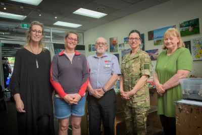 Full body shot of 5 people posing in an art studio