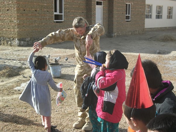 Dr Ellen Nelson dancing with children in Afghanistan