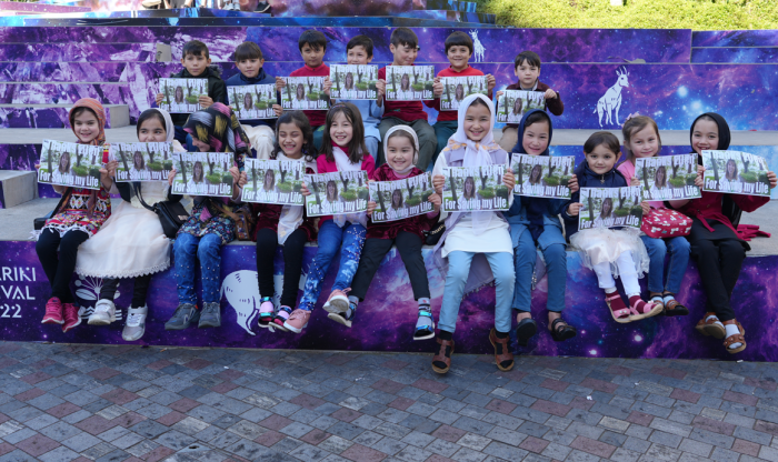 Children holding signs thanking Ellen