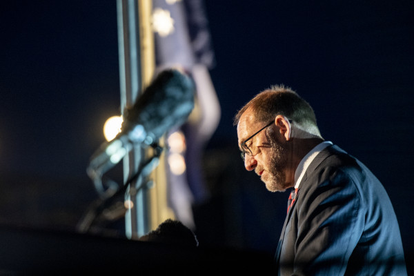 Andrew Little speaking at a podium during dawn