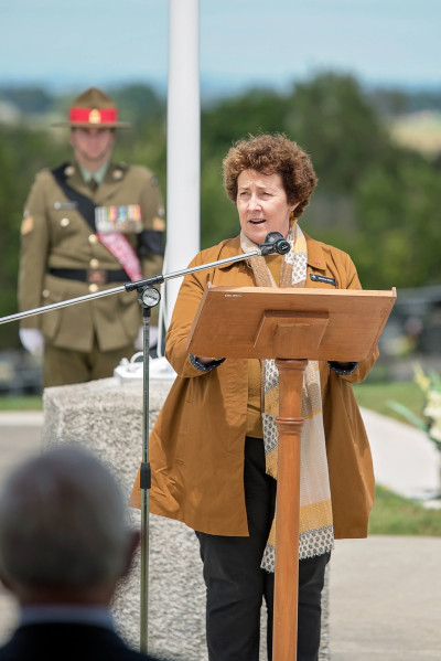 Marti Eller speaking into a microphone at a podium