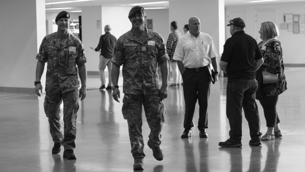 Men in uniform walking in an open building