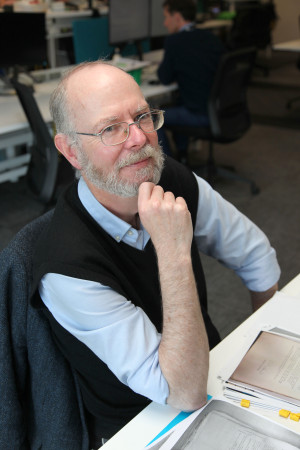 Matthew Buck sitting at a table with documents