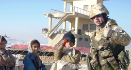 Brett Te Wheoro standing with Afghani children